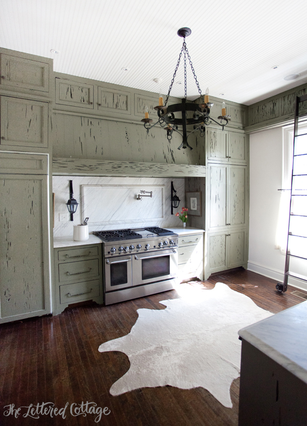 Ashley Gilbreath Interiors | Old Cloverdale House | Montgomery Alabama | Green Kitchen Cabinets | Cowhide Rug | Marble Backsplash